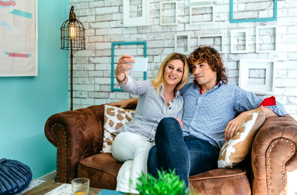 Couple taking selfie on a sofa